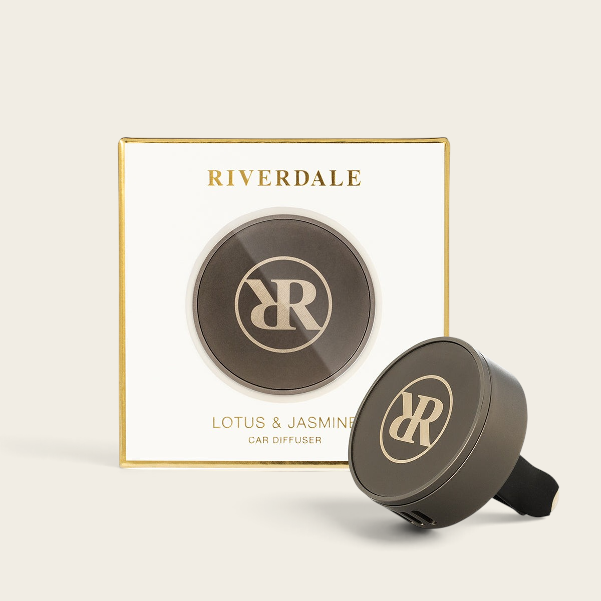 Riverdale Lotus & Jasmine car diffuser set with a round metallic holder and branded packaging box