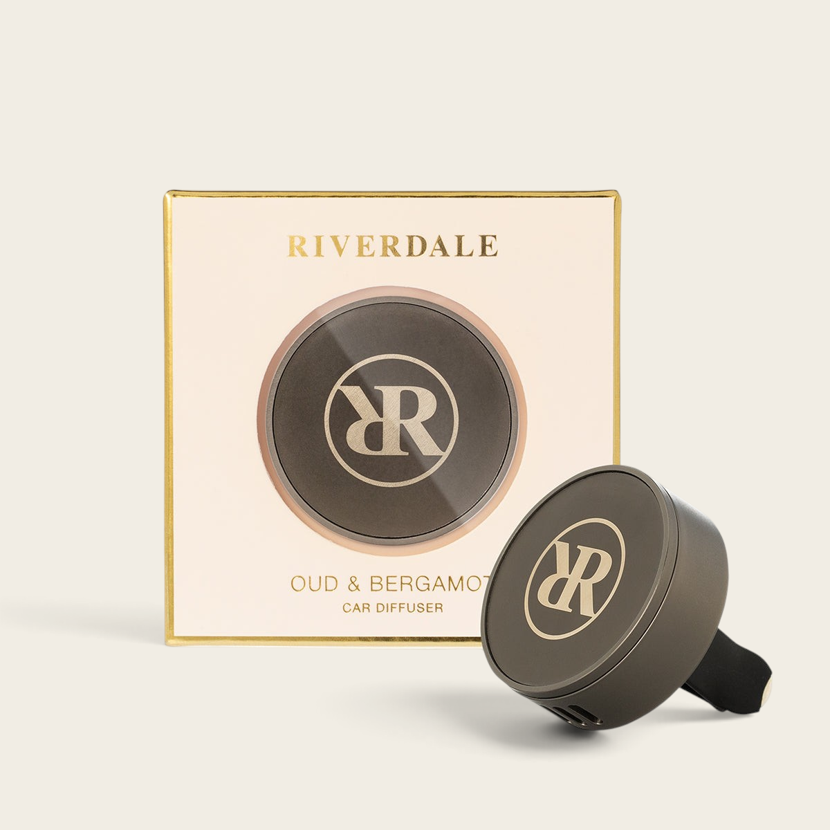 Riverdale car diffuser set with Oud & Bergamot scent, featuring a metallic grey holder and branded packaging.