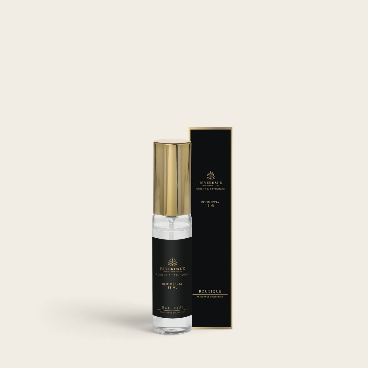 Riverdale Boutique Forest & Patchouli roomspray in a 15ml glass bottle with a gold cap next to its black packaging.