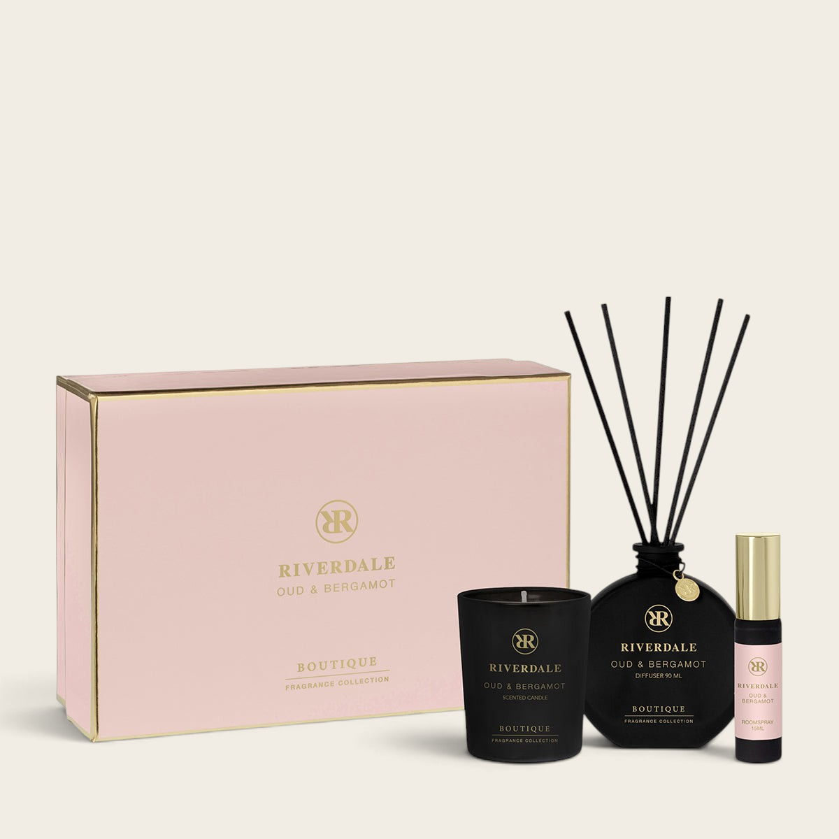 Riverdale Oud & Bergamot gift set featuring a pink box, scented candle, reed diffuser, and roomspray.