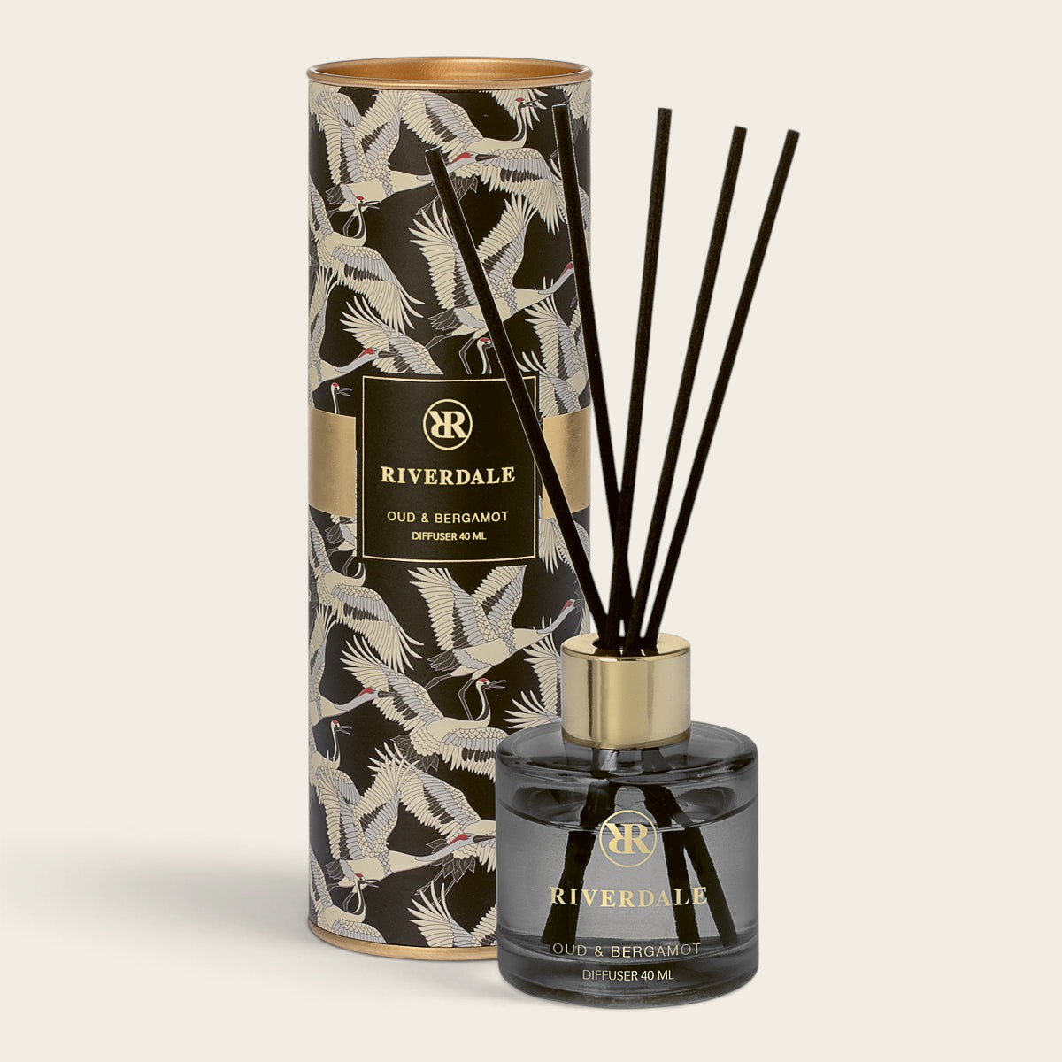 Riverdale Olivia Oud & Bergamot reed diffuser in a glass bottle with black sticks and decorative crane print tube.