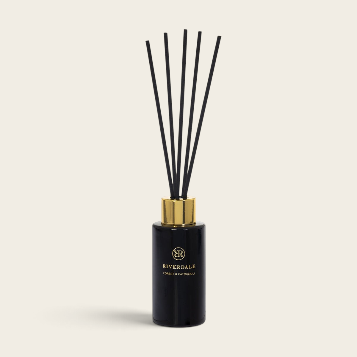 Riverdale Boutique Forest & Patchouli reed diffuser in a sleek black glass bottle with gold cap and black reeds. 