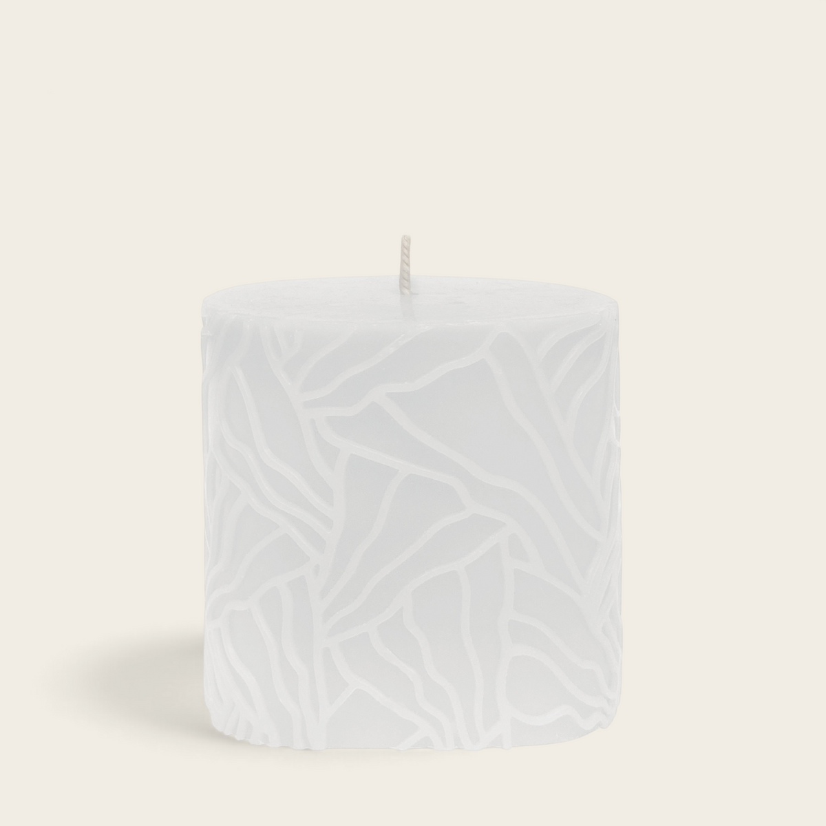 Riverdale white pillar candle with a textured wave pattern, 9x9cm decorative wax candle for home decor.