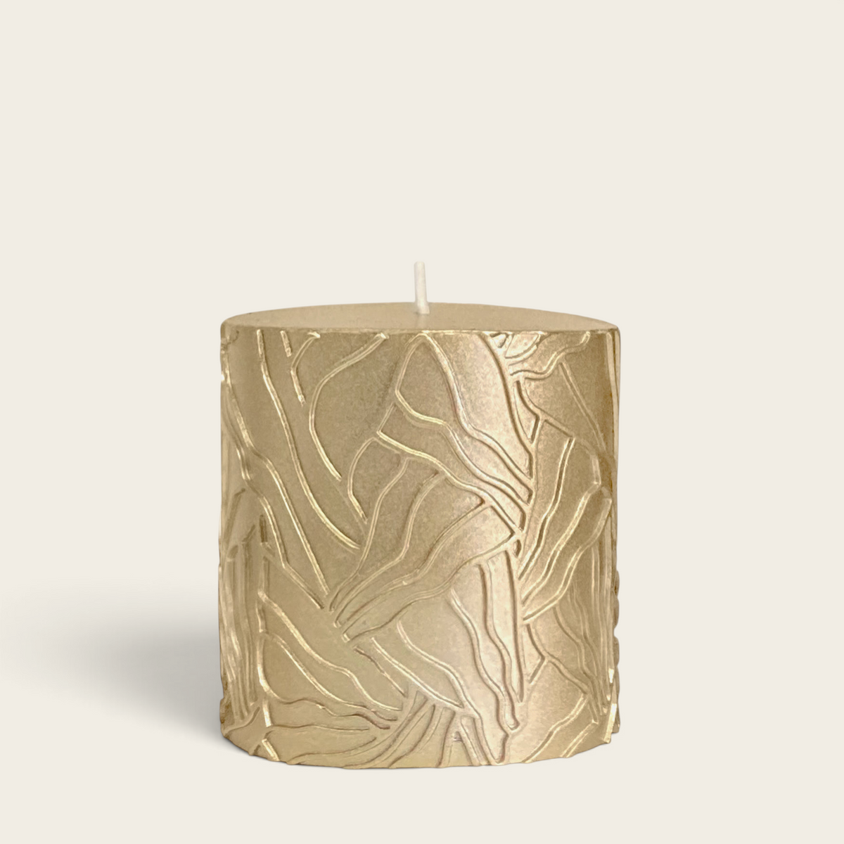 Riverdale gold pillar candle with a textured wave pattern design, 7x7cm size for home decor.