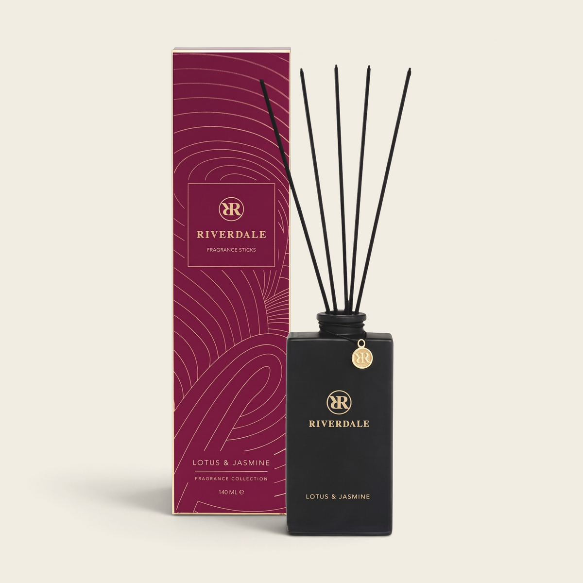 Riverdale Lotus & Jasmine fragrance sticks in a matte black bottle with gold charm and burgundy gift box