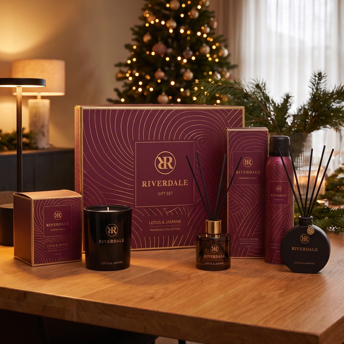 Riverdale Lotus & Jasmine gift set featuring burgundy packaging with gold accents, scented candle, and reed diffusers.