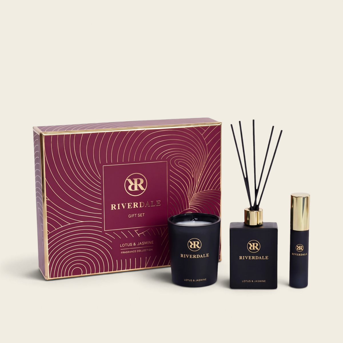 Riverdale Lotus & Jasmine gift set featuring a burgundy box, scented candle, reed diffuser, and home perfume spray.