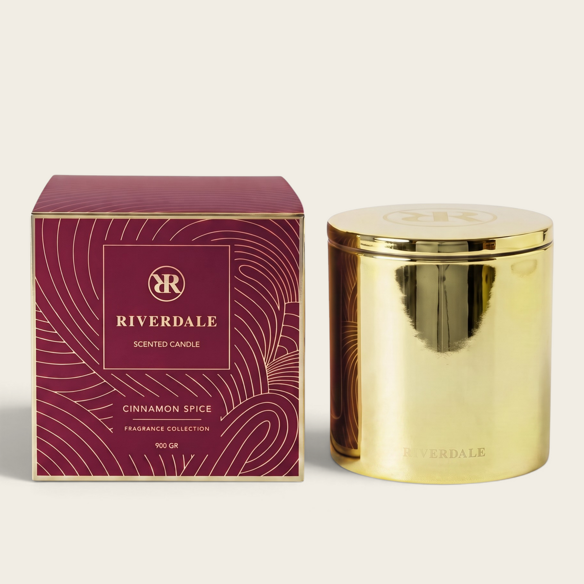 Riverdale Cinnamon Spice scented candle in a gold metallic jar with a matching burgundy gift box
