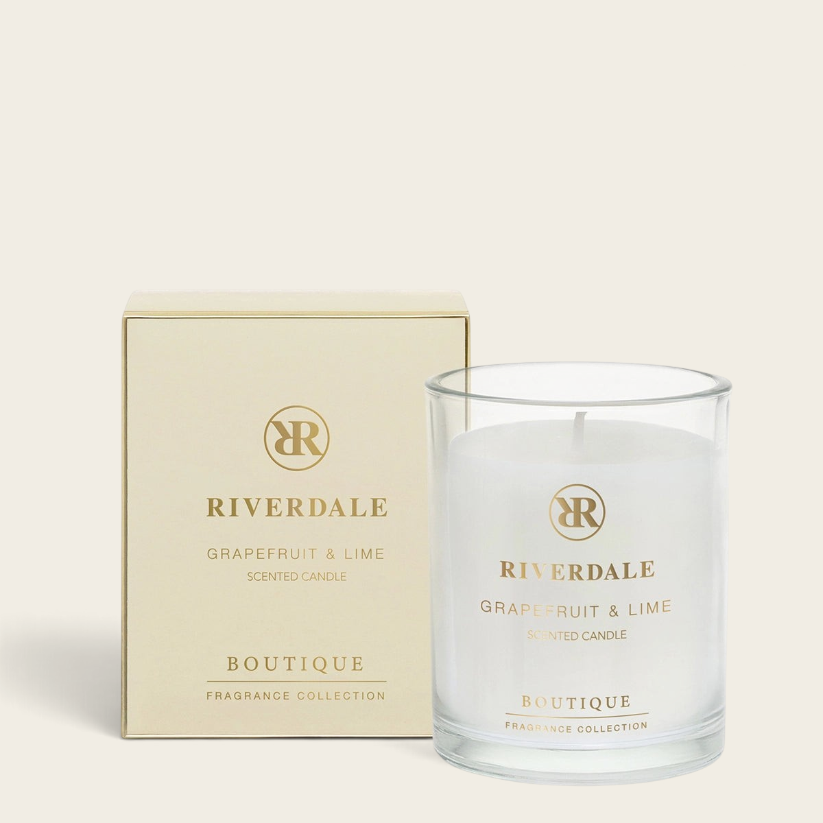 Riverdale Boutique scented candle in a glass jar with matching gold box, featuring Grapefruit and Lime fragrance.