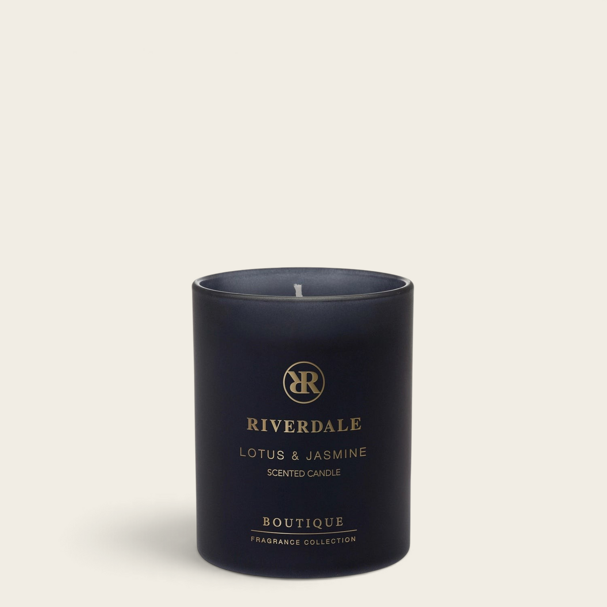 Riverdale Boutique scented candle in a matte black glass jar with Lotus and Jasmine fragrance, 10cm tall.