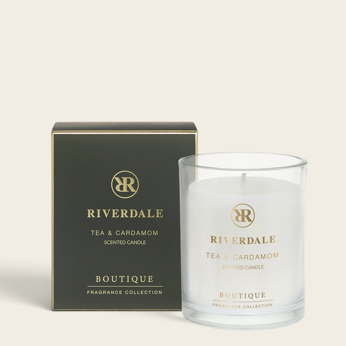 Riverdale Boutique Tea & Cardamom scented candle in a clear glass jar with matching black and gold gift box.