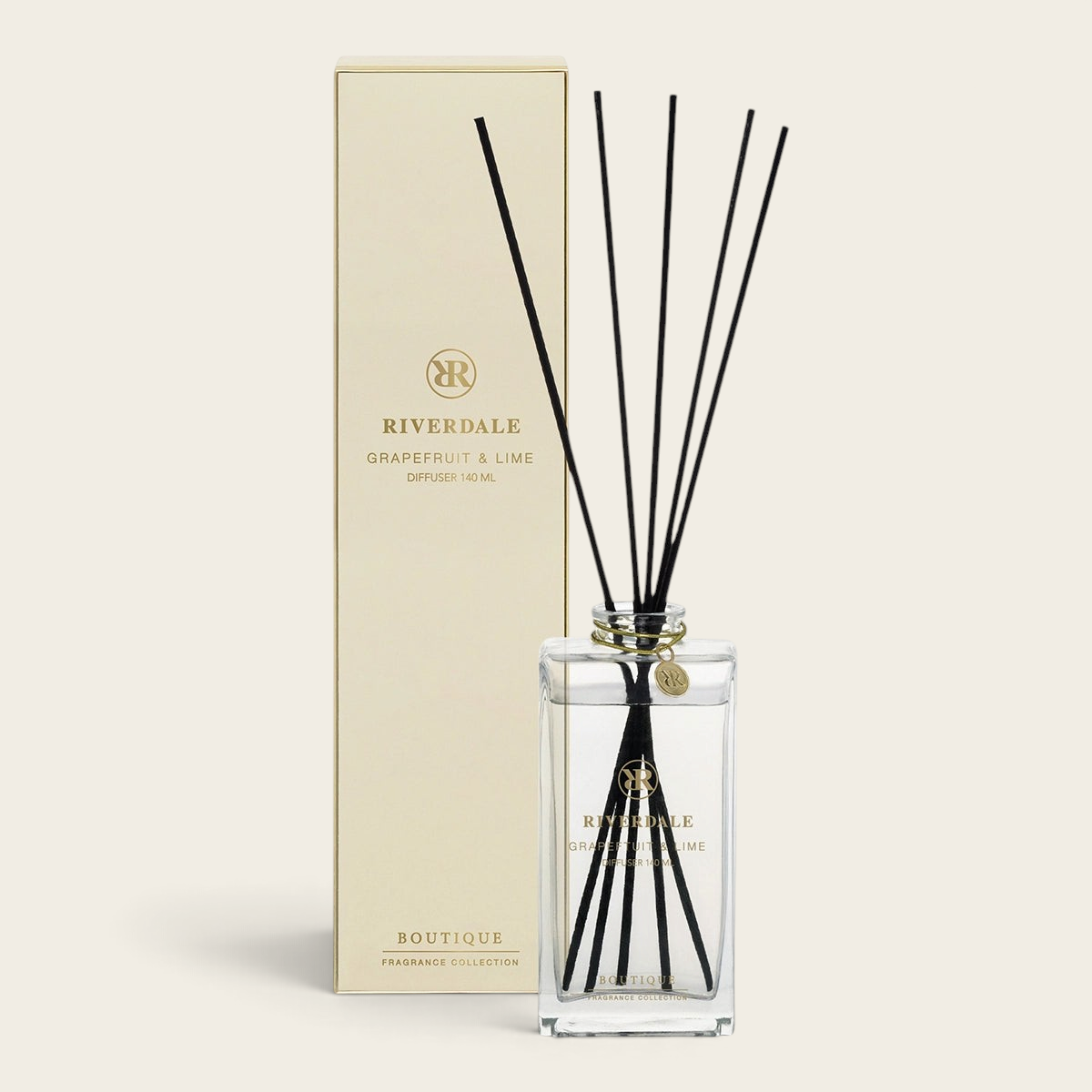 Riverdale Boutique Grapefruit & Lime reed diffuser set with a glass bottle, black reeds, and elegant gold packaging.