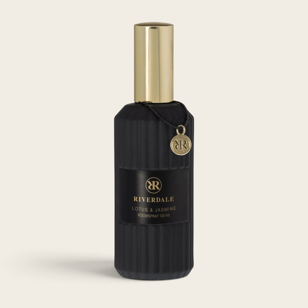 Riverdale Boutique roomspray in a black ribbed glass bottle with a gold cap and branded charm, 100ml size.