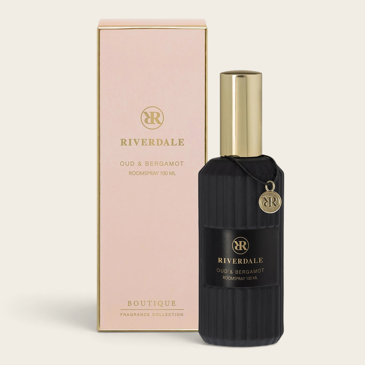 Riverdale Boutique Oud & Bergamot roomspray in a black ribbed glass bottle with gold cap and matching gift box.