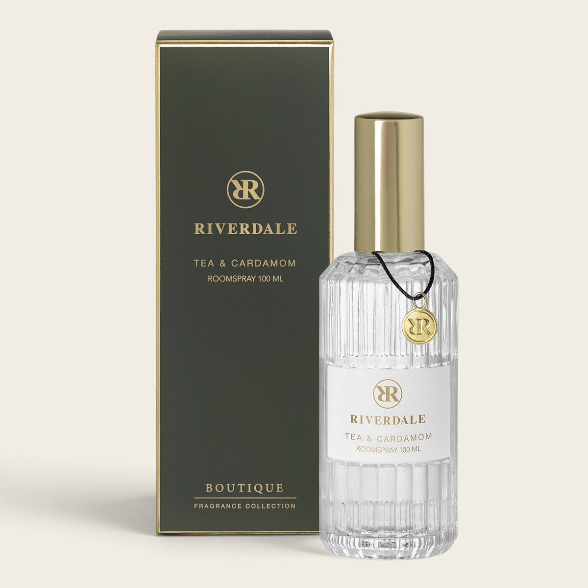 Riverdale Boutique Tea & Cardamom roomspray in a 100ml glass bottle with gold cap and matching dark green gift box.