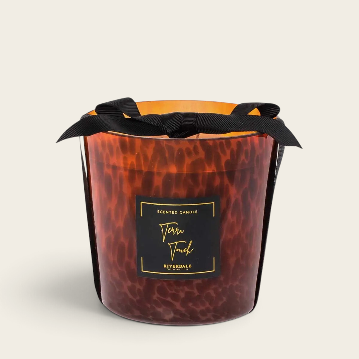 Riverdale Sense M Terra Touch scented candle in a brown glass jar with a decorative leopard print and black ribbon.