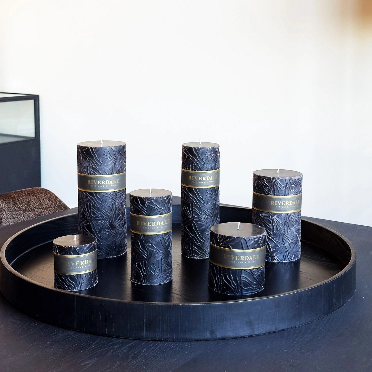 Riverdale Wave pillar candles in black with textured oyster mushroom-inspired surface arranged on a round black tray