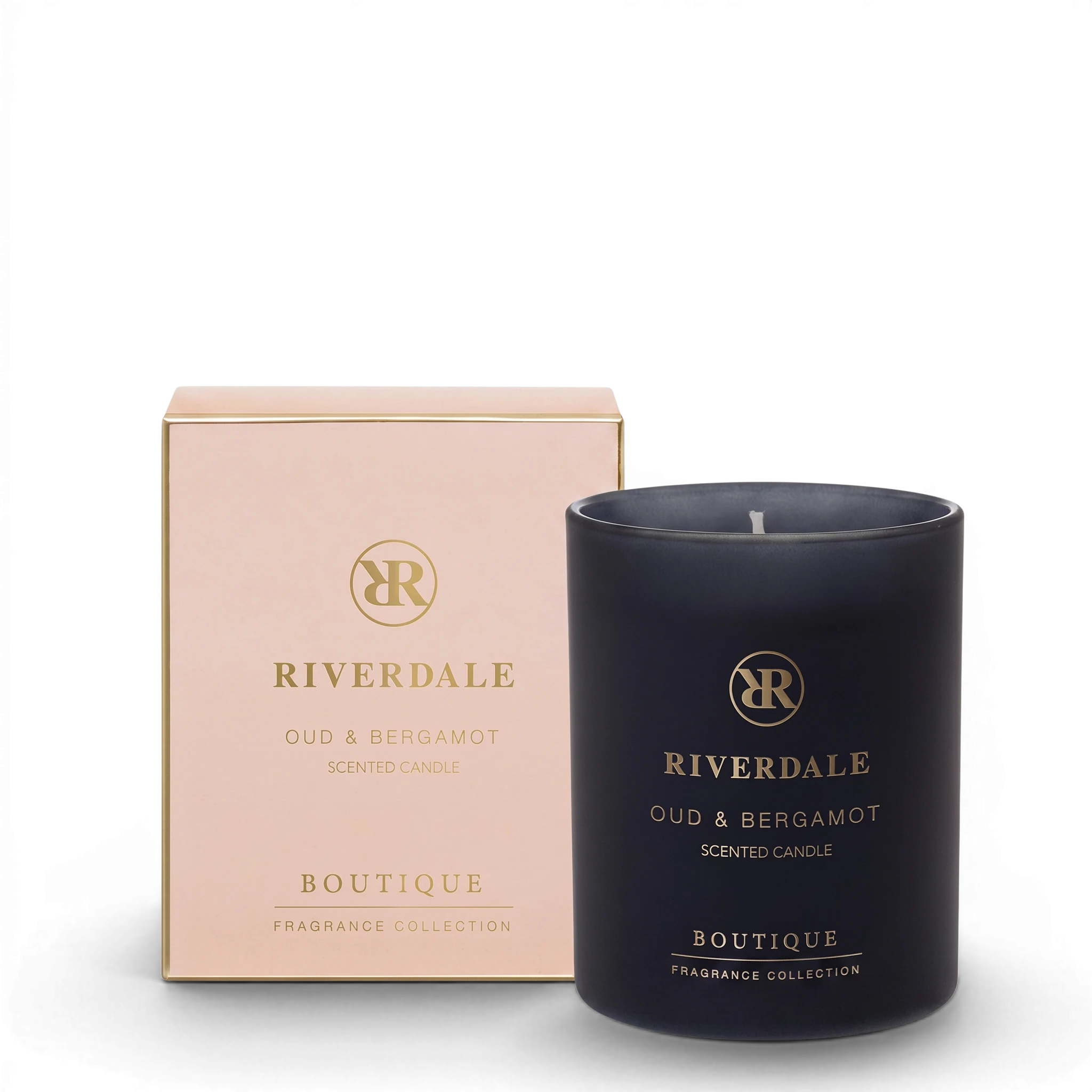 Riverdale Boutique Oud & Bergamot scented candle in a black glass jar with its matching light pink gift box.